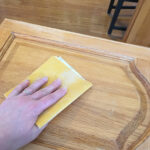 kitchen cupboard door being sanded